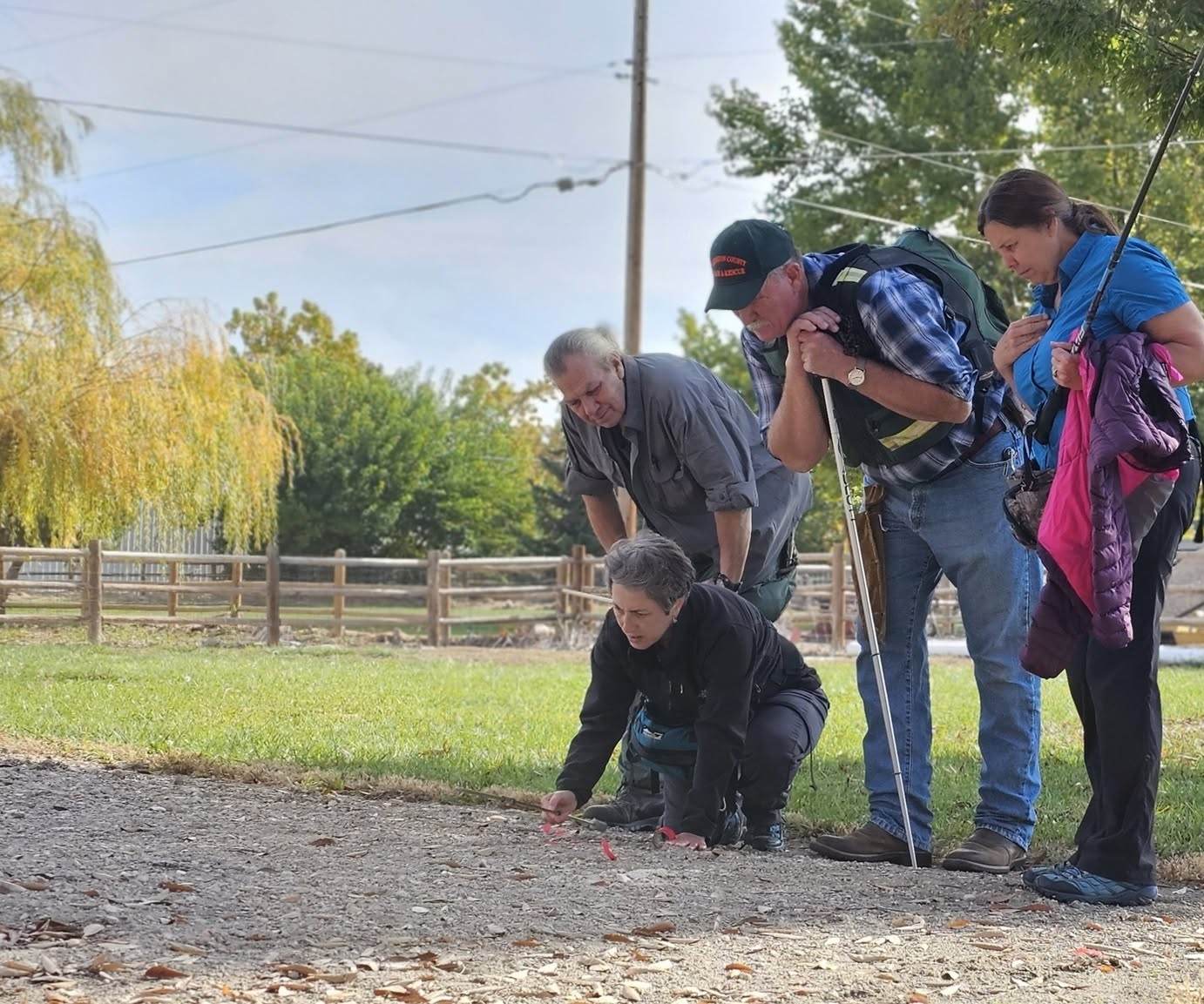 IRIS investigators examining ground sign during a field search